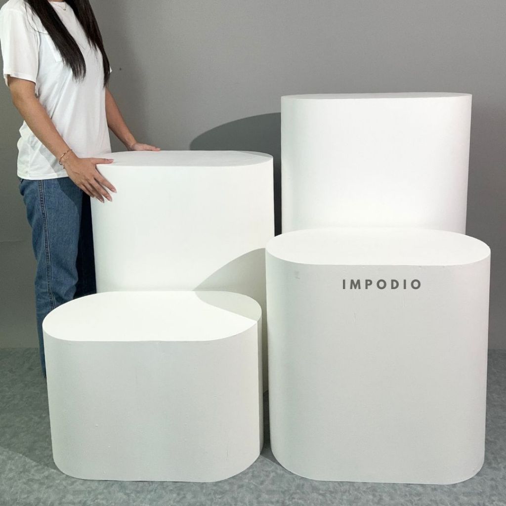 White cylindrical furniture pieces with 'Impodio' branding on a gray background